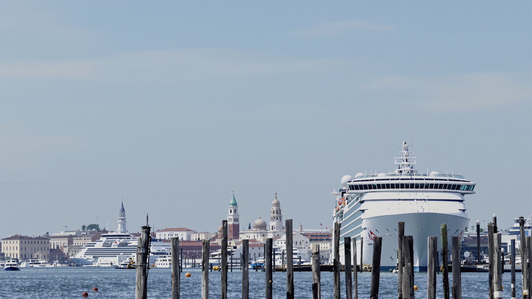 Editorial illustration of a cruise ship docked at Marghera with Venice in the background, evoking environmental awareness.